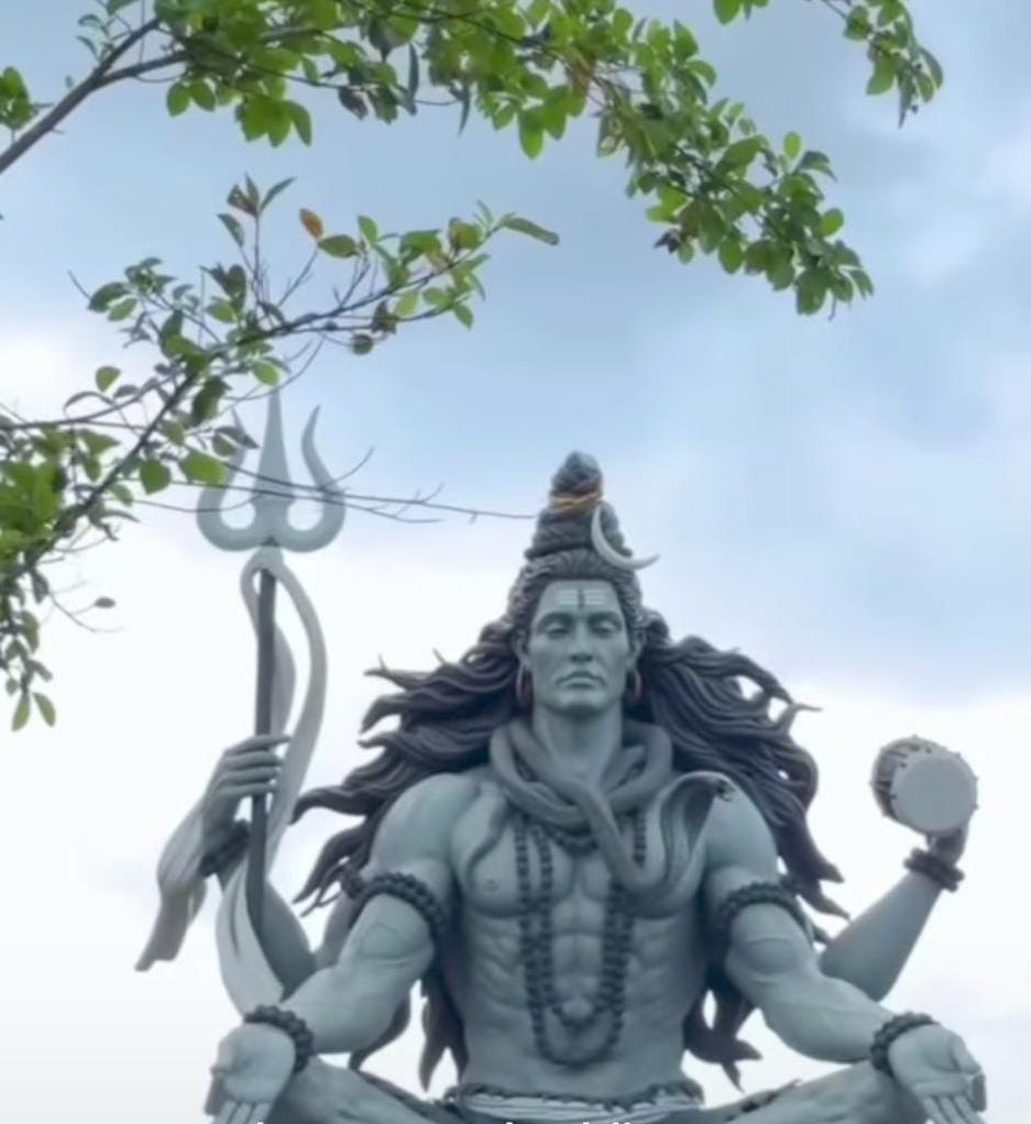 Close-up view of the Shiva statue's trident and flowing drapery